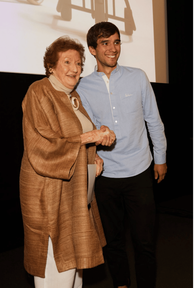 A woman, Lady Helen Hamlyn, shaking hands with a man, Michael Strantz 